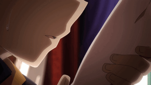 A Close Up Of A Person Holding A Piece Of Paper In Their Hand GIF