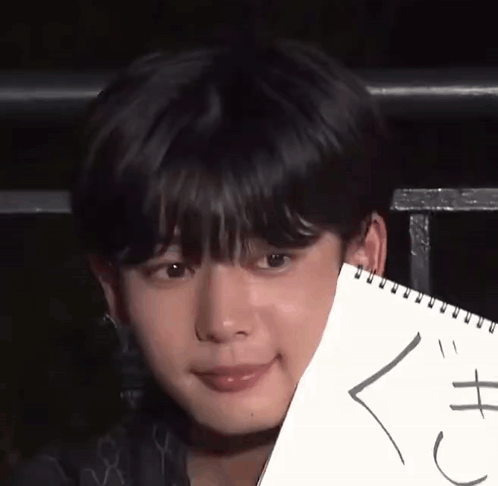 A Close Up Of A Person Holding A Piece Of Paper That Says ' X ' On It GIF