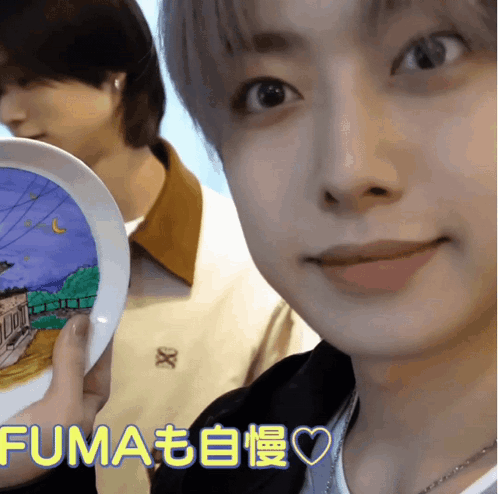 A Close Up Of A Person Holding A Plate That Says Fuma On The Bottom GIF