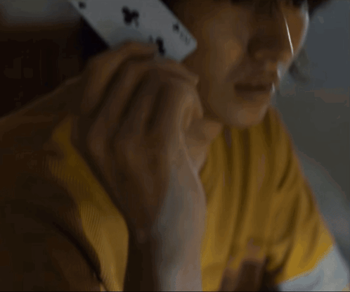A Close Up Of A Person Holding A Playing Card With The Number 4 On It GIF