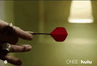A Close Up Of A Person Holding A Red Dart With The Word Hulu On The Bottom GIF
