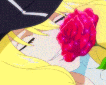A Close Up Of A Person Holding A Red Rose In Their Mouth GIF