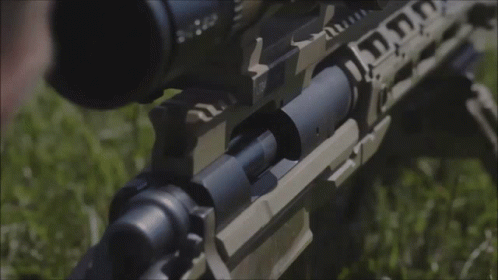 A Close Up Of A Person Holding A Rifle With A Scope That Says ' Tactical ' On It GIF