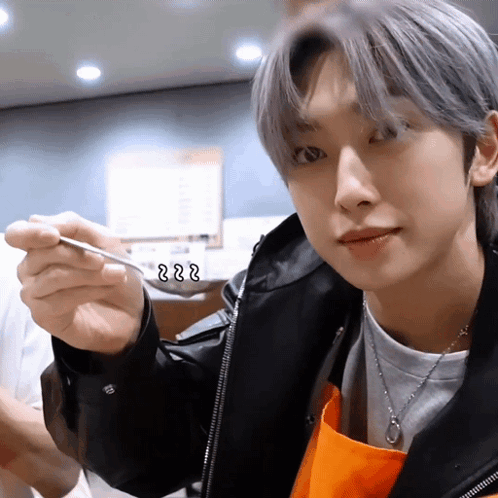 A Close Up Of A Person Holding A Spoon With The Letters Zzz Written On It GIF
