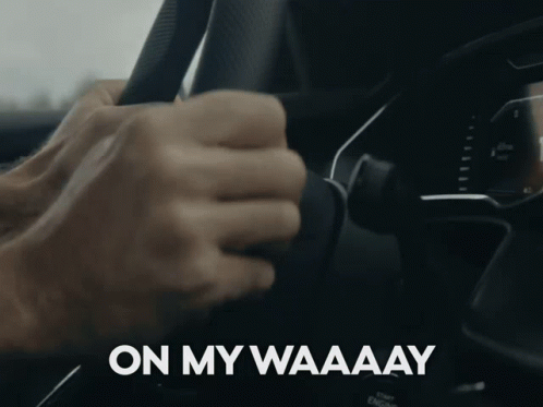 A Close Up Of A Person Holding A Steering Wheel With The Words On My Waaaay Written On The Bottom GIF