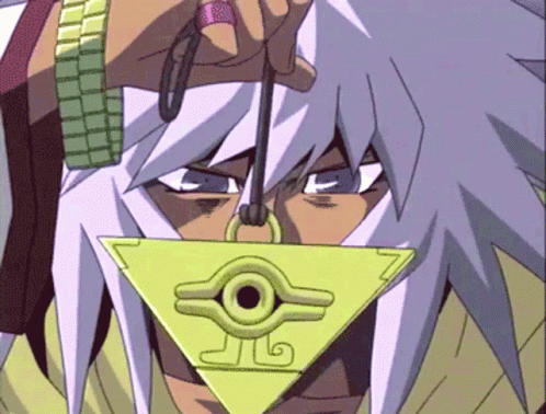 A Close Up Of A Person Holding A Triangle Shaped Pendant With A Circle In The Middle GIF