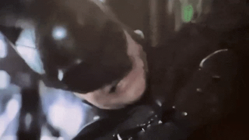 A Close Up Of A Person In A Batman Costume GIF