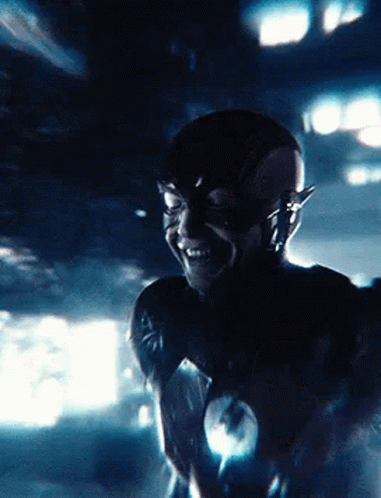 A Close Up Of A Person In A Flash Costume Smiling . GIF