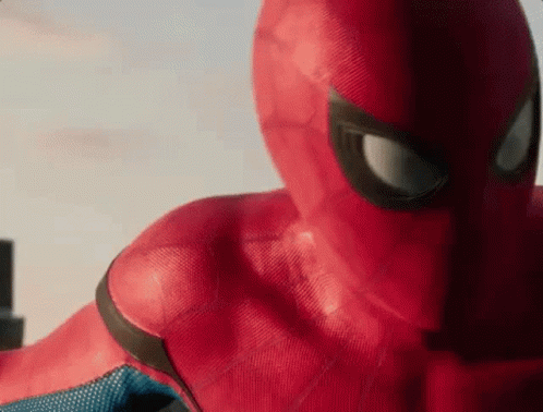 A Close Up Of A Person In A Spiderman Costume Looking At The Camera . GIF