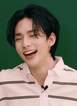 A Close Up Of A Person Laughing With Their Eyes Closed And Their Mouth Open . GIF