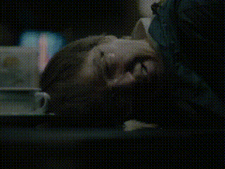 A Close Up Of A Person Laying Down With Their Head On A Table GIF