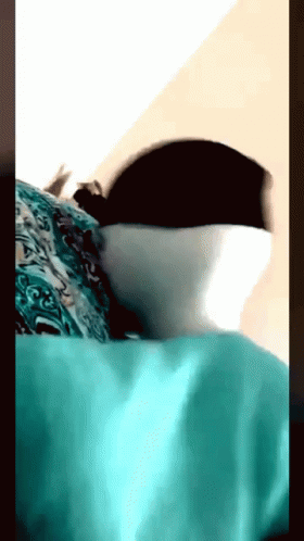 A Close Up Of A Person Laying On A Bed GIF