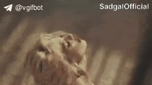 A Close Up Of A Person Laying On The Ground With The Words Sadgal Official On The Bottom . GIF