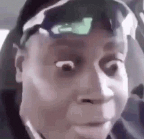 A Close Up Of A Person Making A Funny Face While Wearing Sunglasses And A Hat . GIF