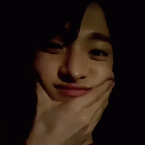 A Close Up Of A Person Making A Funny Face With Their Hand On Their Face . GIF