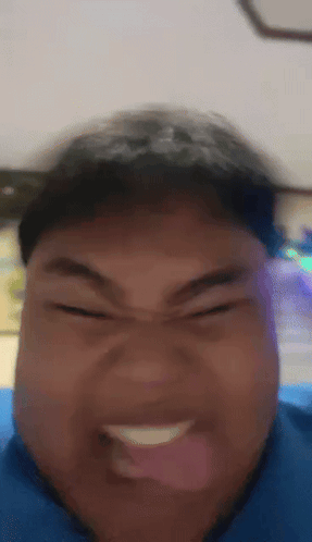 A Close Up Of A Person Making A Funny Face With Their Tongue Out GIF
