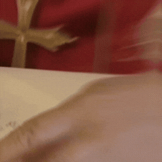 A Close Up Of A Person Opening A Gift Box GIF
