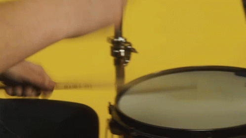A Close Up Of A Person Playing A Drum Set GIF