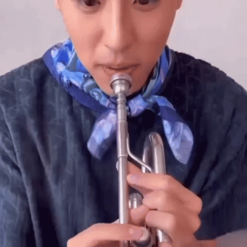 A Close Up Of A Person Playing A Trumpet . GIF
