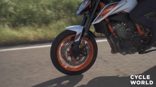 A Close Up Of A Person Riding A Motorcycle With The Words Cycle World On The Bottom Right GIF