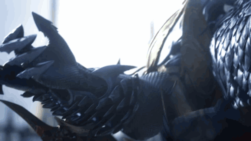 A Close Up Of A Person 'S Arm With Sharp Claws And Feathers GIF