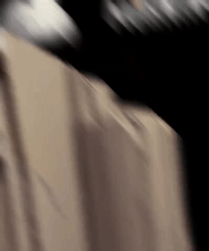 A Close Up Of A Person 'S Back With A Black Background GIF