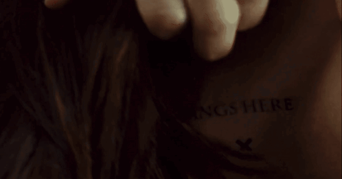 A Close Up Of A Person 'S Back With The Words Insert Fangs Here Written On It GIF