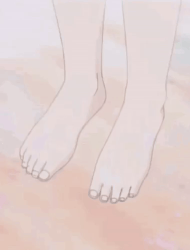 a close up of a person 's bare feet on a sandy surface .