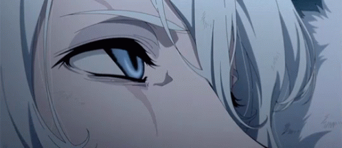 A Close Up Of A Person 'S Blue Eye With White Hair GIF