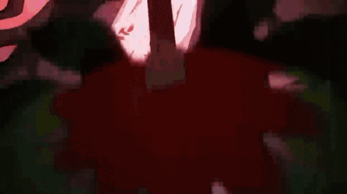 A Close Up Of A Person 'S Chest In A Dark Room With A Red Light Coming Out Of It . GIF