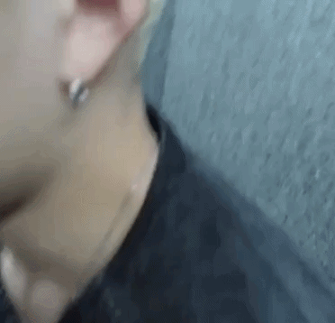 A Close Up Of A Person 'S Ear And Neck With Earrings . GIF