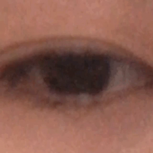 A Close Up Of A Person 'S Eye With A Black Pupil GIF