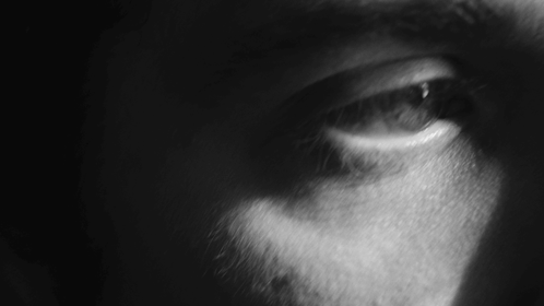 A Close Up Of A Person 'S Eye With A Dark Background GIF