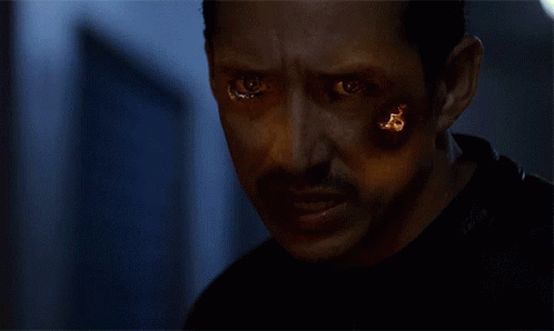 A Close Up Of A Person 'S Face Covered In Fire GIF