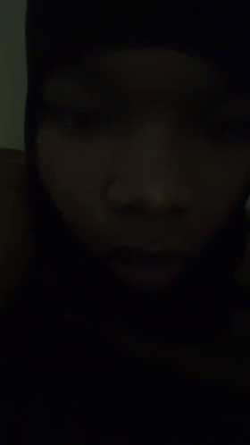 A Close Up Of A Person 'S Face In A Dark Room . GIF