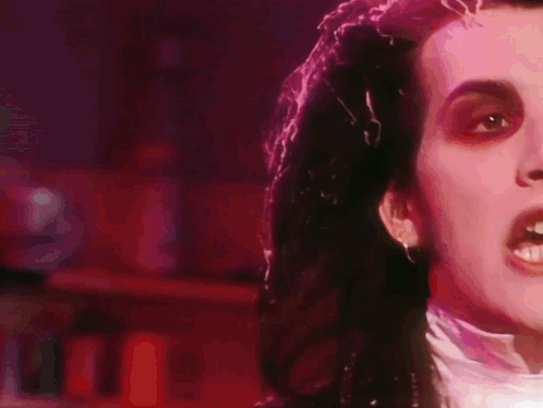 A Close Up Of A Person 'S Face In A Dark Room GIF
