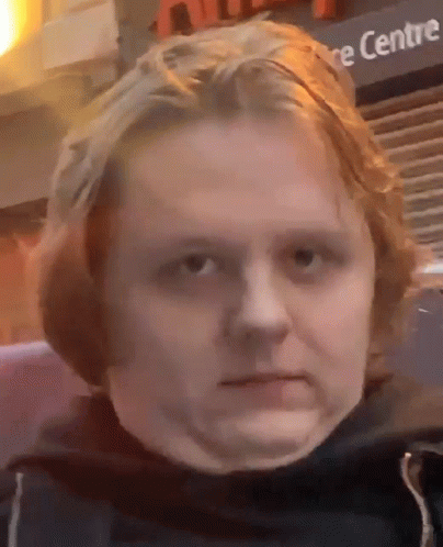 A Close Up Of A Person 'S Face In Front Of A Sign That Says ' Centre ' GIF