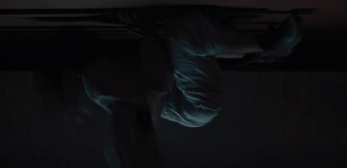 A Close Up Of A Person 'S Face In The Dark With A Green Light Coming Out Of It . GIF