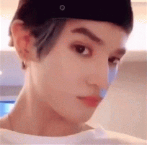 A Close Up Of A Person 'S Face Wearing A Hat And A Bandage On Their Nose . GIF