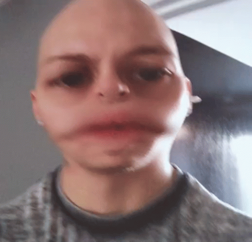 A Close Up Of A Person 'S Face With A Bald Head . GIF