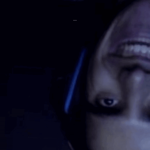 A Close Up Of A Person 'S Face With A Barcode In The Background That Says ' R & A ' GIF