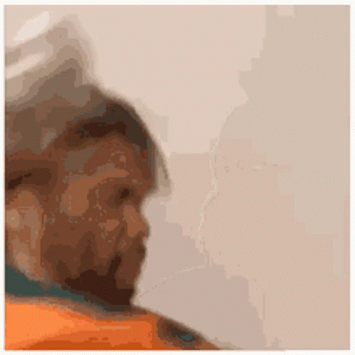 A Close Up Of A Person 'S Face With A Beard And A Blurred Background . GIF