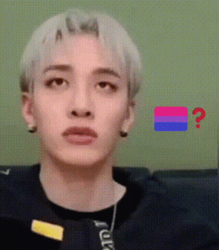 A Close Up Of A Person 'S Face With A Bisexual Flag In The Background And A Question Mark . GIF
