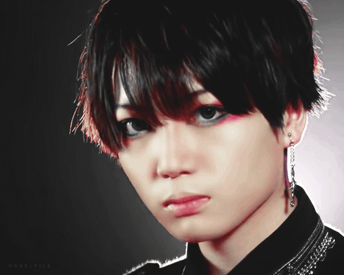 A Close Up Of A Person 'S Face With A Black Background And The Letters Aa And Ea On The Bottom GIF