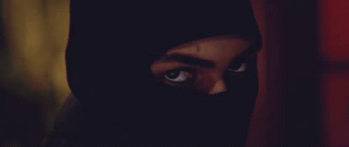 A Close Up Of A Person 'S Face With A Black Mask On GIF