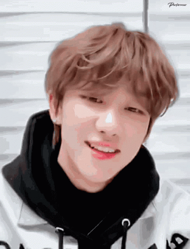 A Close Up Of A Person 'S Face With A Black Scarf Around His Neck GIF
