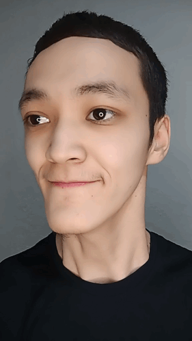 A Close Up Of A Person 'S Face With A Black Shirt GIF