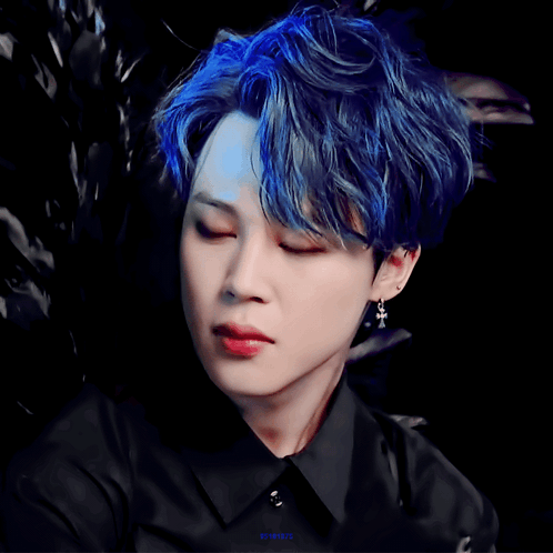 A Close Up Of A Person 'S Face With A Black Shirt And Blue Hair GIF