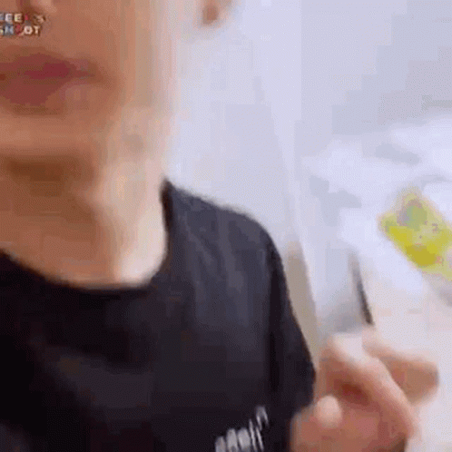 A Close Up Of A Person 'S Face With A Black Shirt On And A Backpack On . GIF