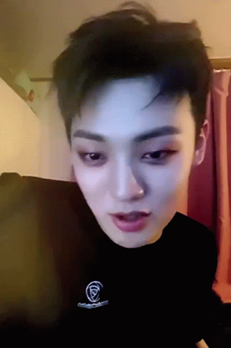 A Close Up Of A Person 'S Face With A Black Shirt That Has The Letter F On It GIF